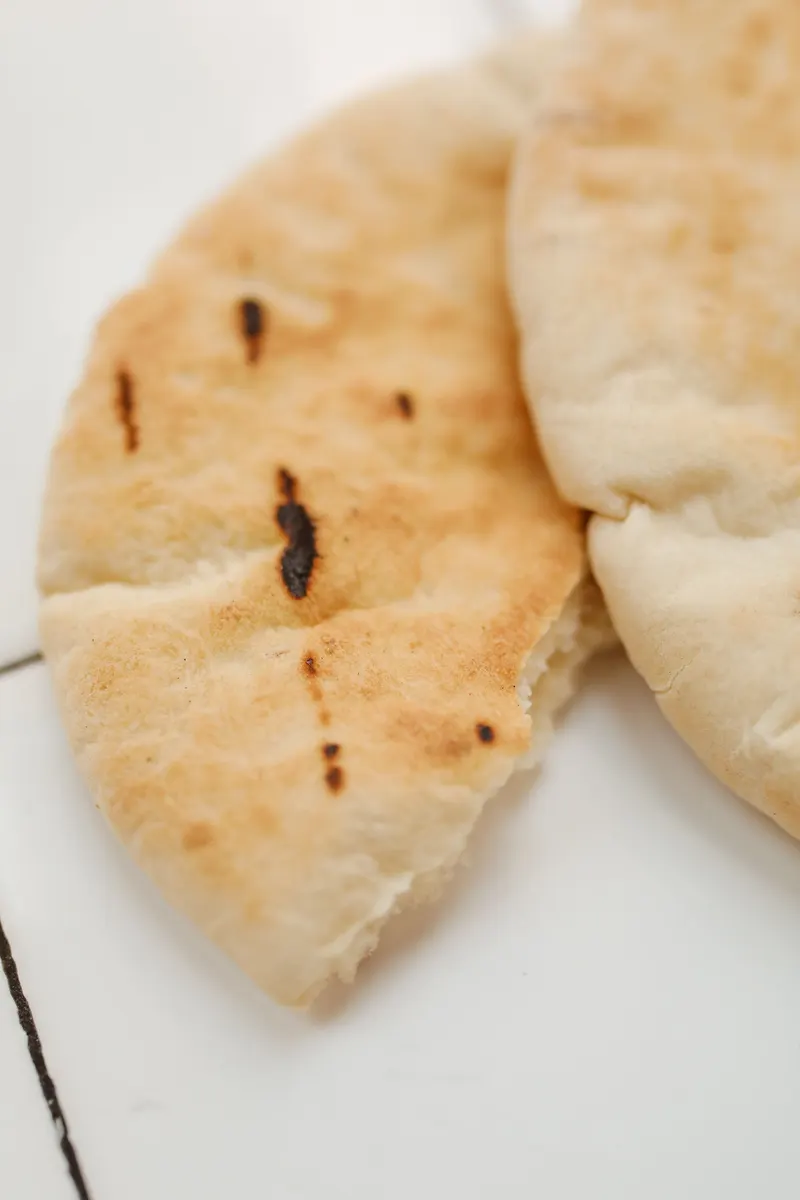 Flat pita bread on a white surface